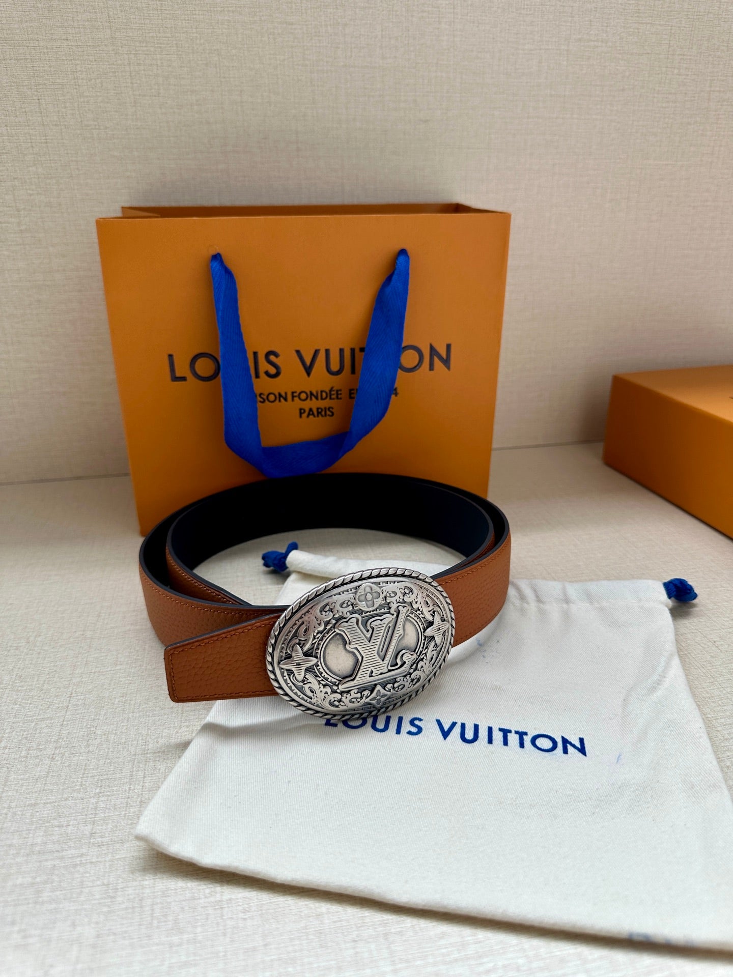 Brown leather belt with silver-tone oval logo buckle and matching gift set