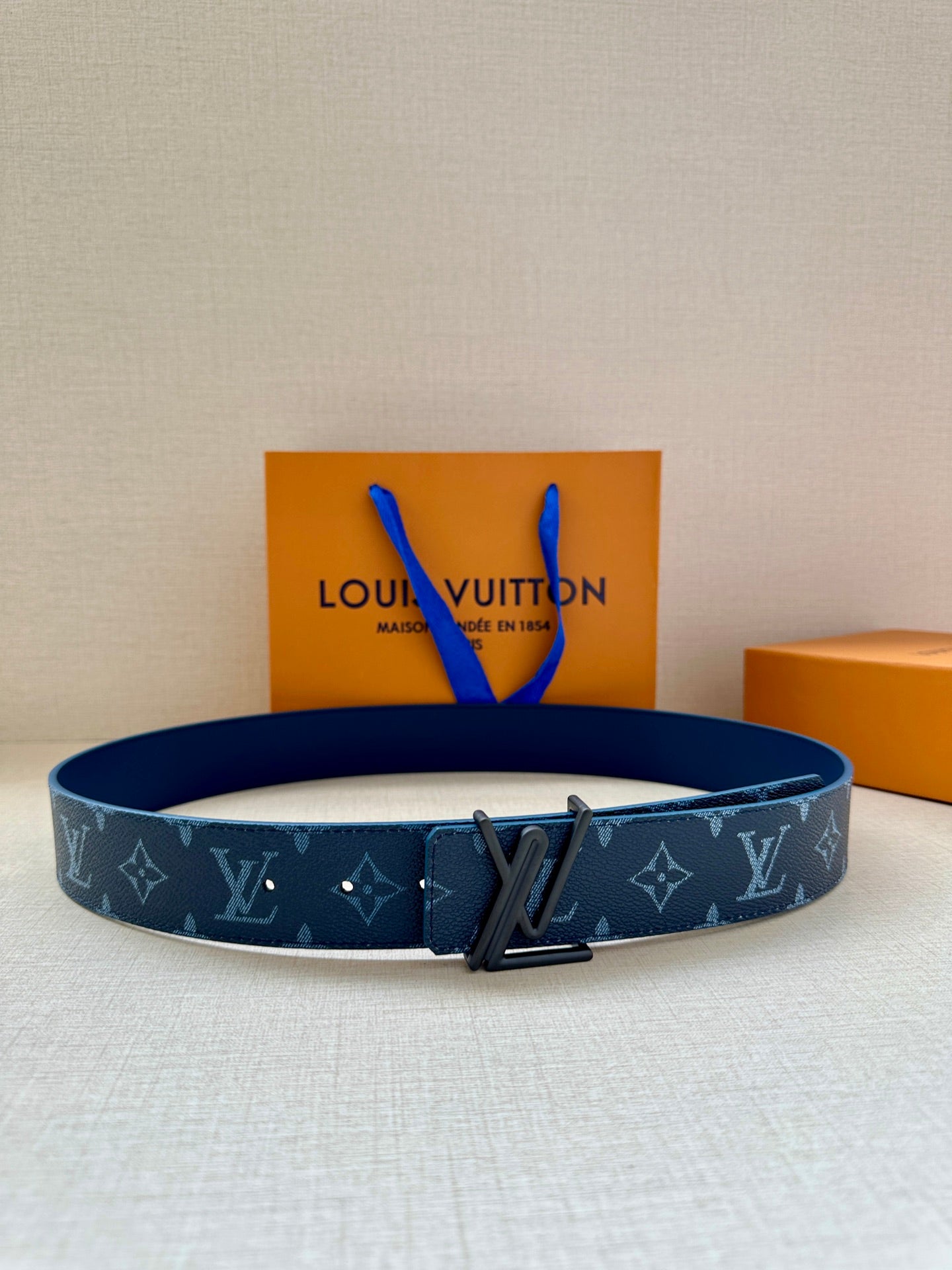 Blue monogram belt with dark metal LV-style buckle