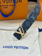 Navy monogram belt with gold-tone LV buckle, close-up