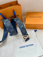 Navy monogram belt with gold-tone V-shaped buckle and blue ends