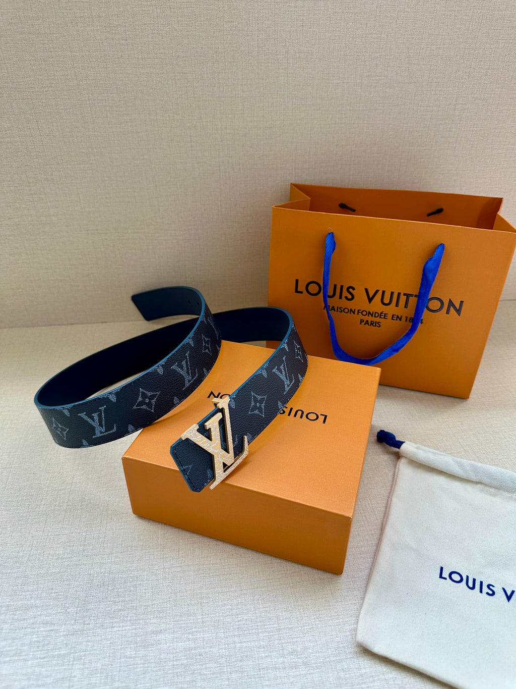 Navy monogram belt with gold-tone buckle, with Louis Vuitton boxes
