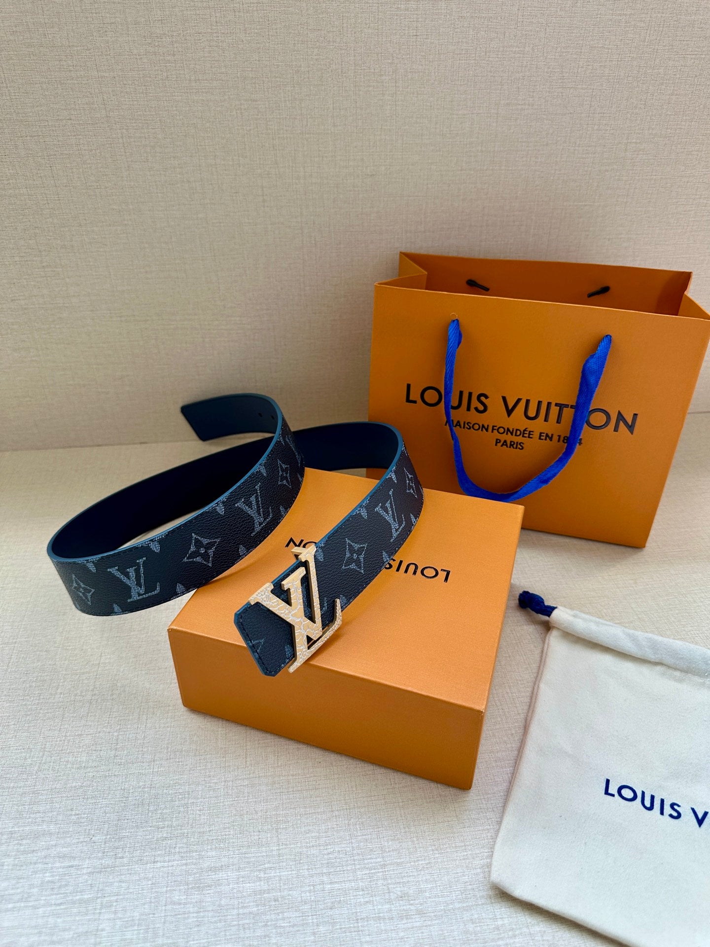 Navy monogram belt with gold-tone buckle, with Louis Vuitton boxes