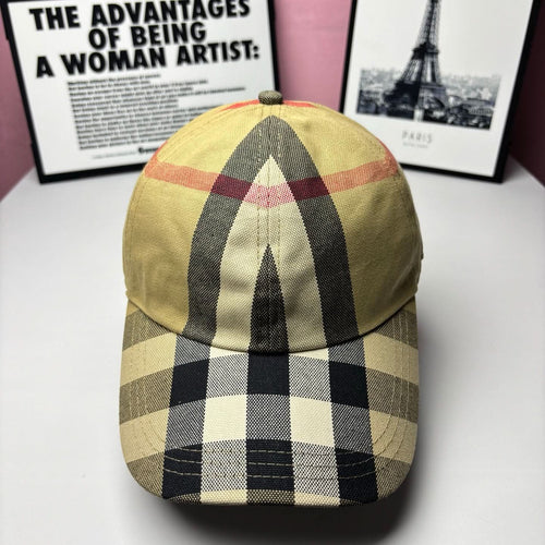 Burberry baseball cap in yellow, black, and red check plaid with curved brim