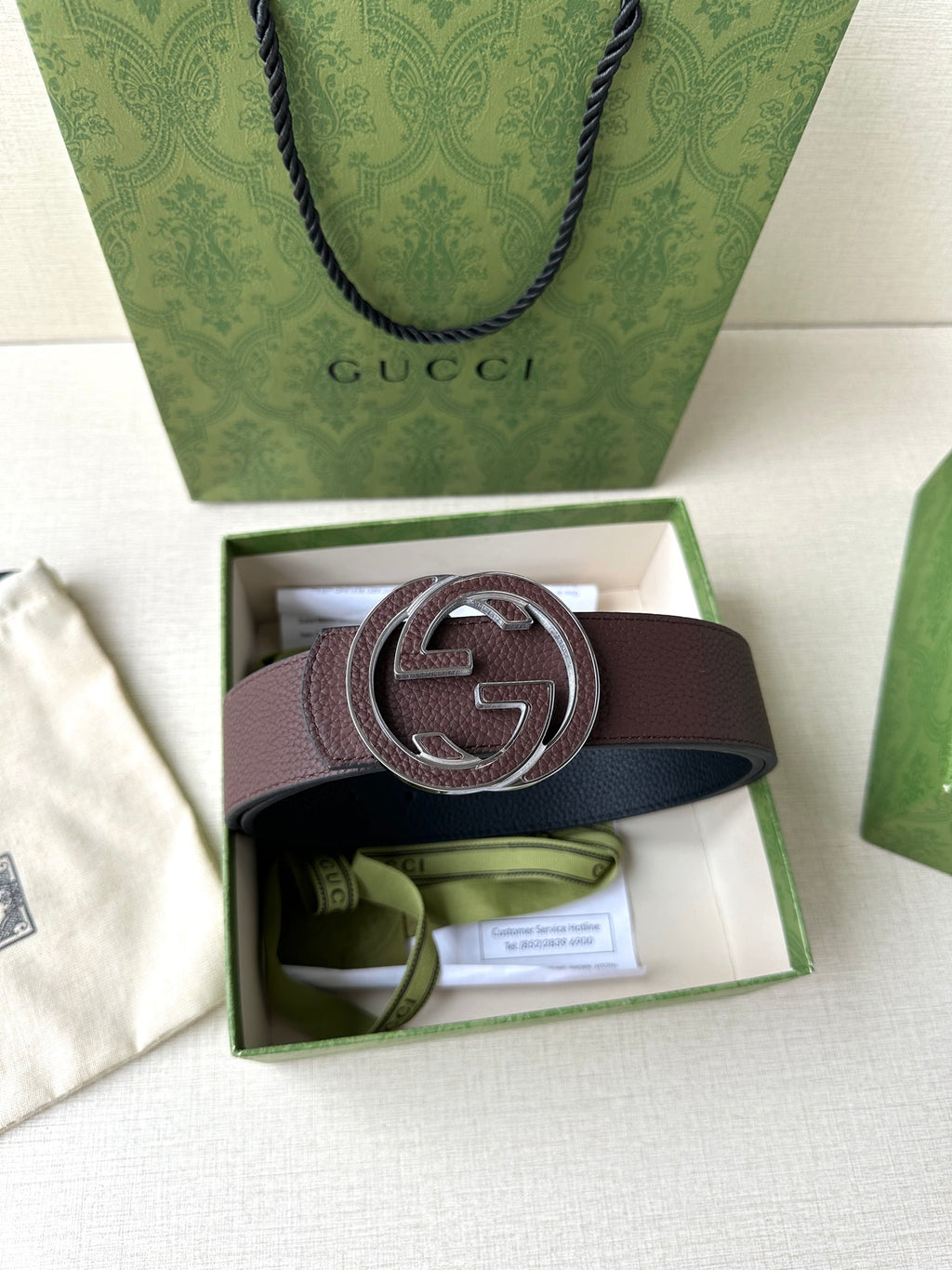 Brown leather belt with silver-tone interlocking G buckle in open gift box
