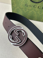 Brown leather belt with silver-tone interlocking G buckle, close-up view
