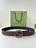 Gucci belt in dark brown leather with gold-tone GG buckle, shown flat