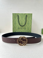 Gucci belt in dark brown leather with gold-tone GG buckle, shown flat