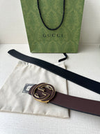 Gucci belt laid out with dark brown strap and gold-tone GG buckle