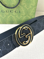 Gucci belt close-up: dark GG pattern strap and gold-tone double G buckle