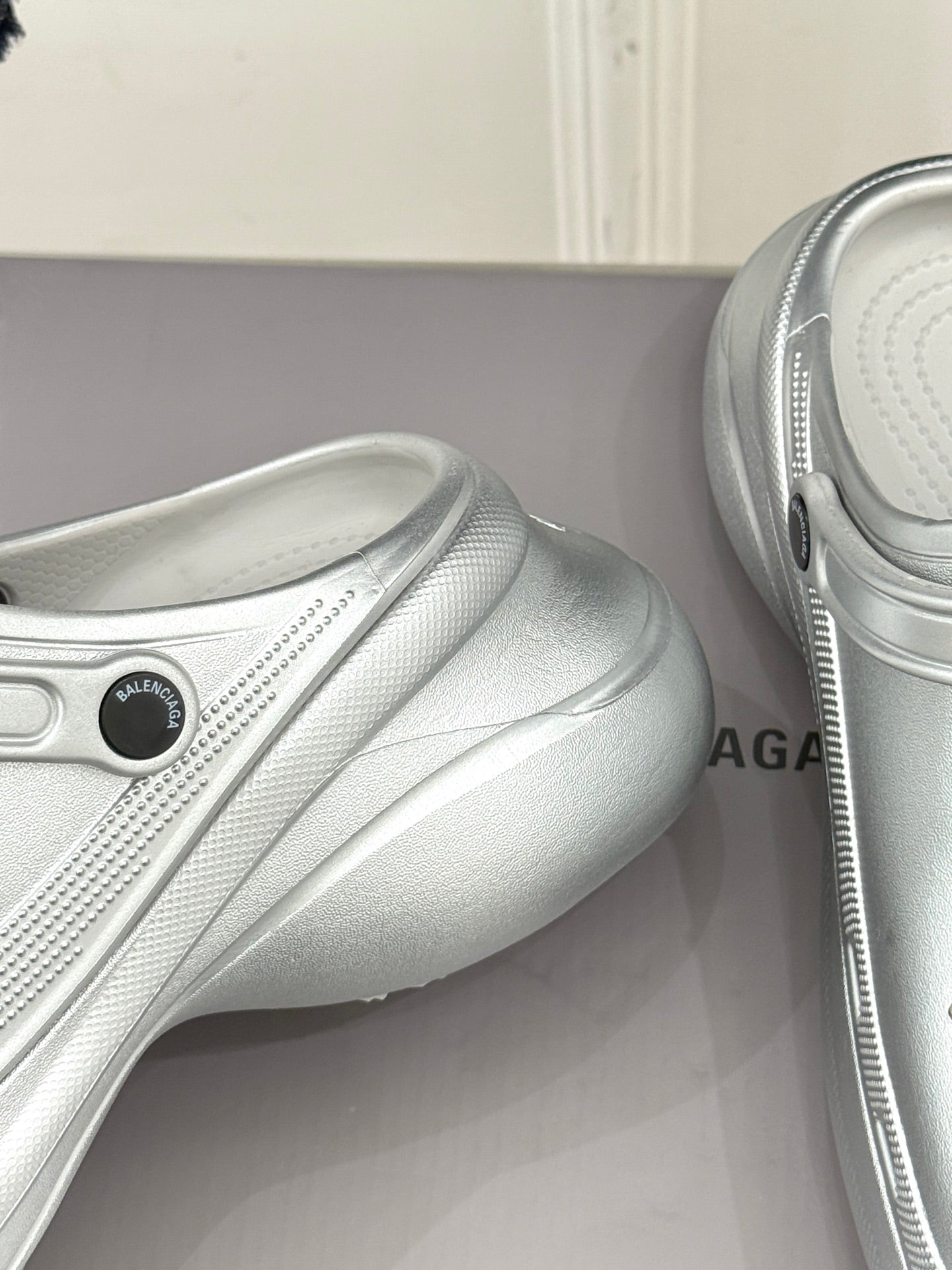 Balenciaga ladies silver slip-on sneaker toe and side with round logo patch