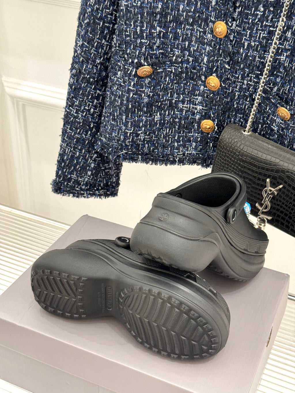 Black platform slide sneakers with thick tread sole and rear strap