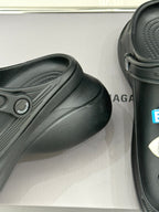 Black slide sneaker with textured upper and molded strap detail