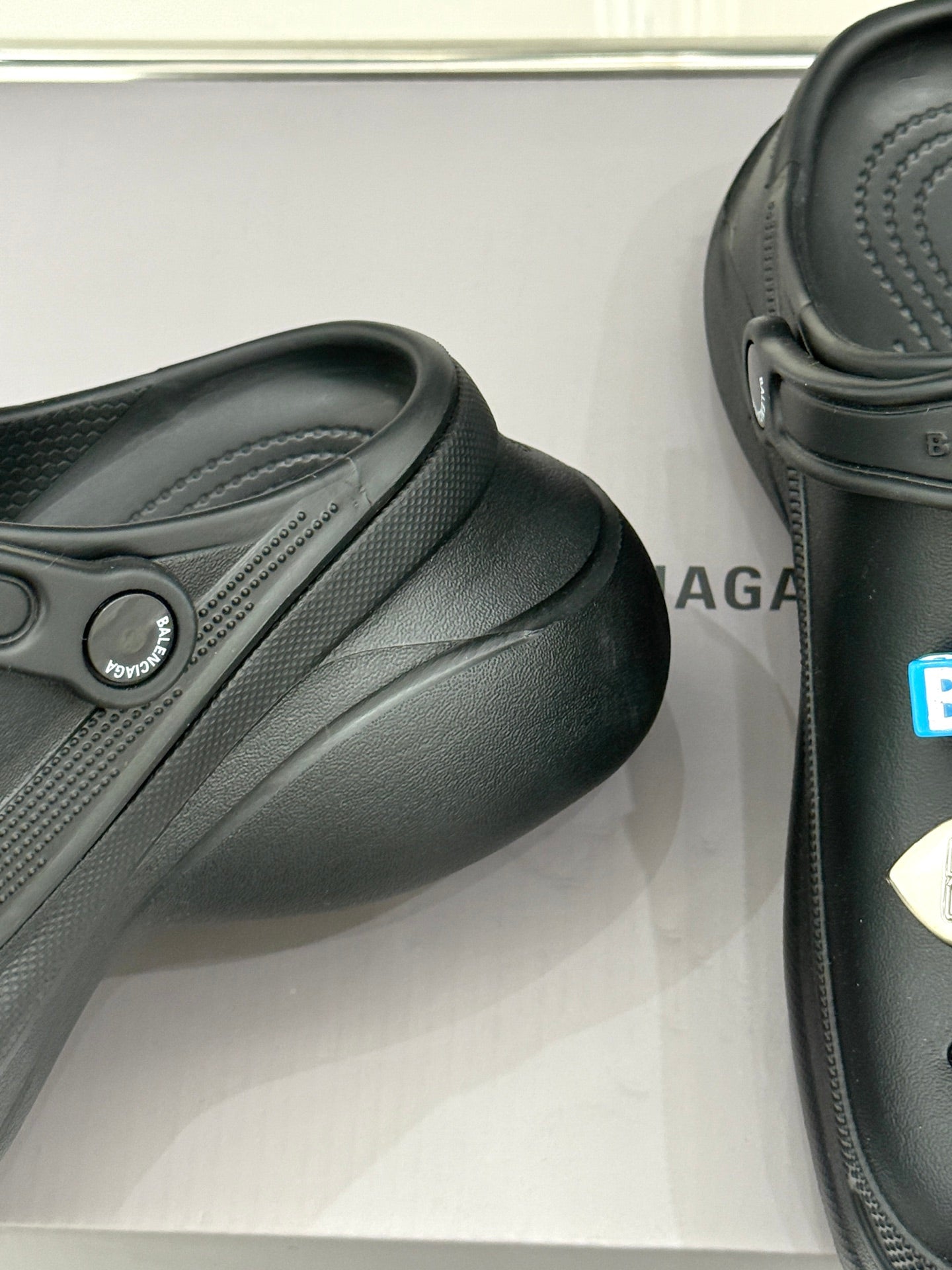 Black slide sneaker with textured upper and molded strap detail