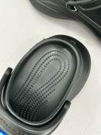 Black slide sneaker footbed with embossed logo and textured tread