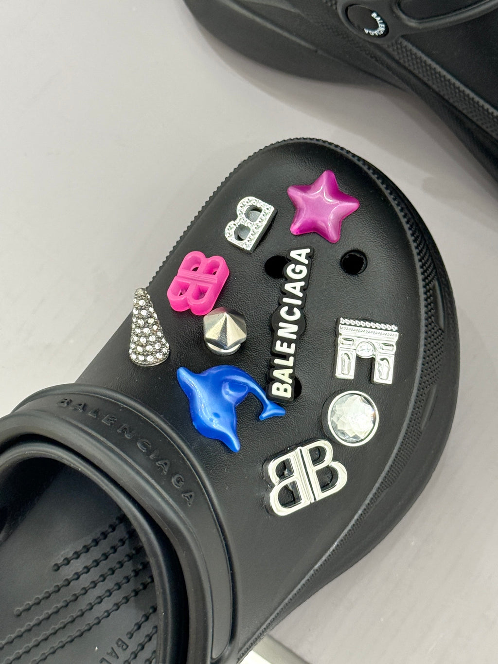 Black slide sneaker with star charms and small logo charm details