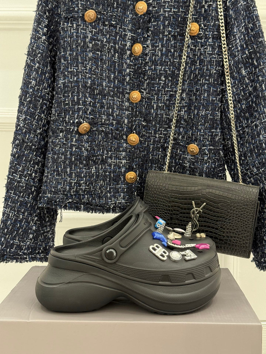 Black platform slide sneakers with front strap and decorative charm patches