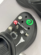 Balenciaga black clog with front studded charms and curved green accent