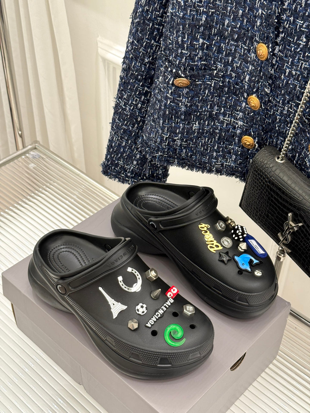 Balenciaga black studded slip-on clogs on display, front view