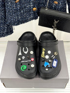Balenciaga black slip-on clogs with front studded charms, pair on box
