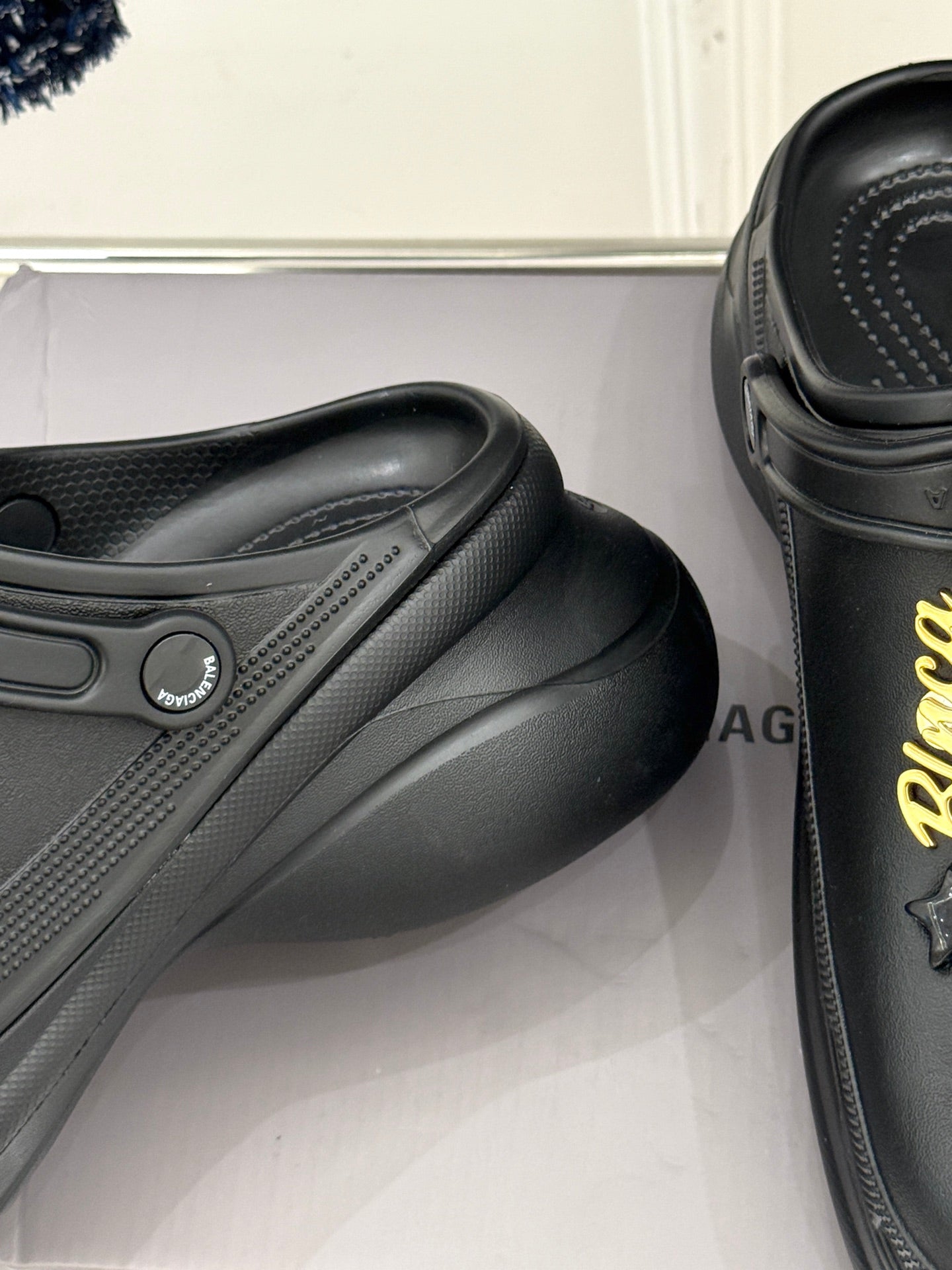 Balenciaga black leather-style slip-on clog, close-up side detail