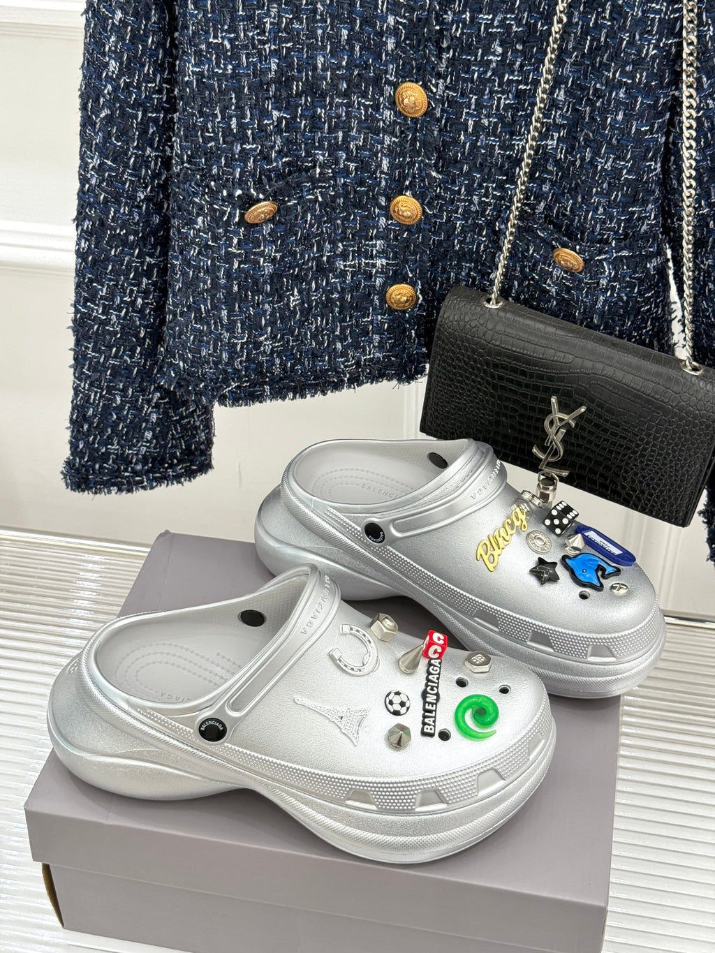 White platform clog shoes with colorful sticker charms and curved top