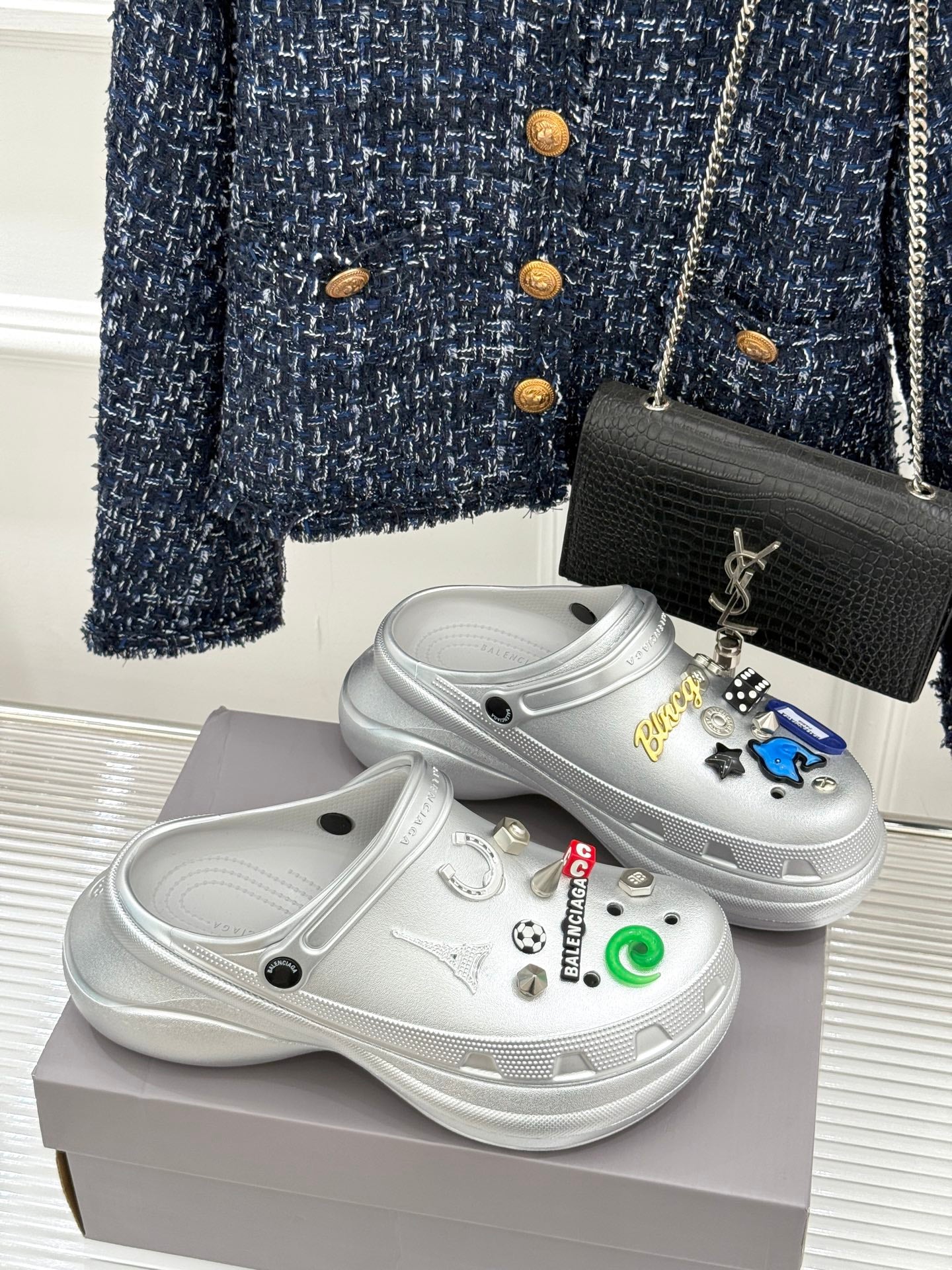 White platform clog shoes with colorful sticker charms and curved top