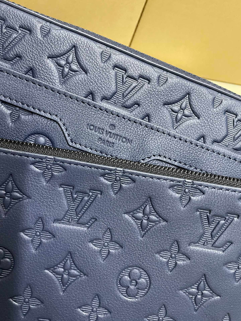 Navy monogram pouch with embossed pattern and zipper