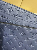 Navy monogram pouch with embossed pattern and zipper