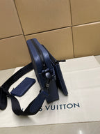 Navy monogram crossbody bag with adjustable shoulder strap and handle detail