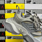 Gray Balenciaga lace-up sneaker with “B” logo, wavy sole and yellow trim