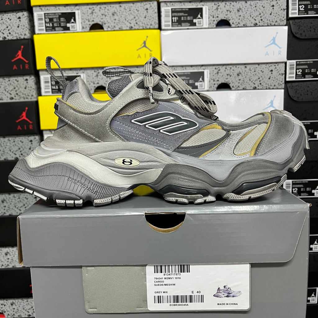 Gray Balenciaga lace-up sneaker with mesh panels and yellow stripe accents, chunky sole
