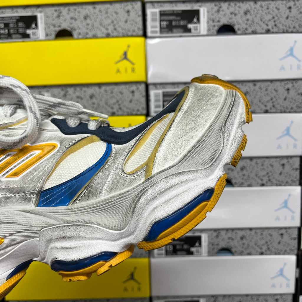 Balenciaga unisex sneaker side view in silver with blue stripe and gold sole