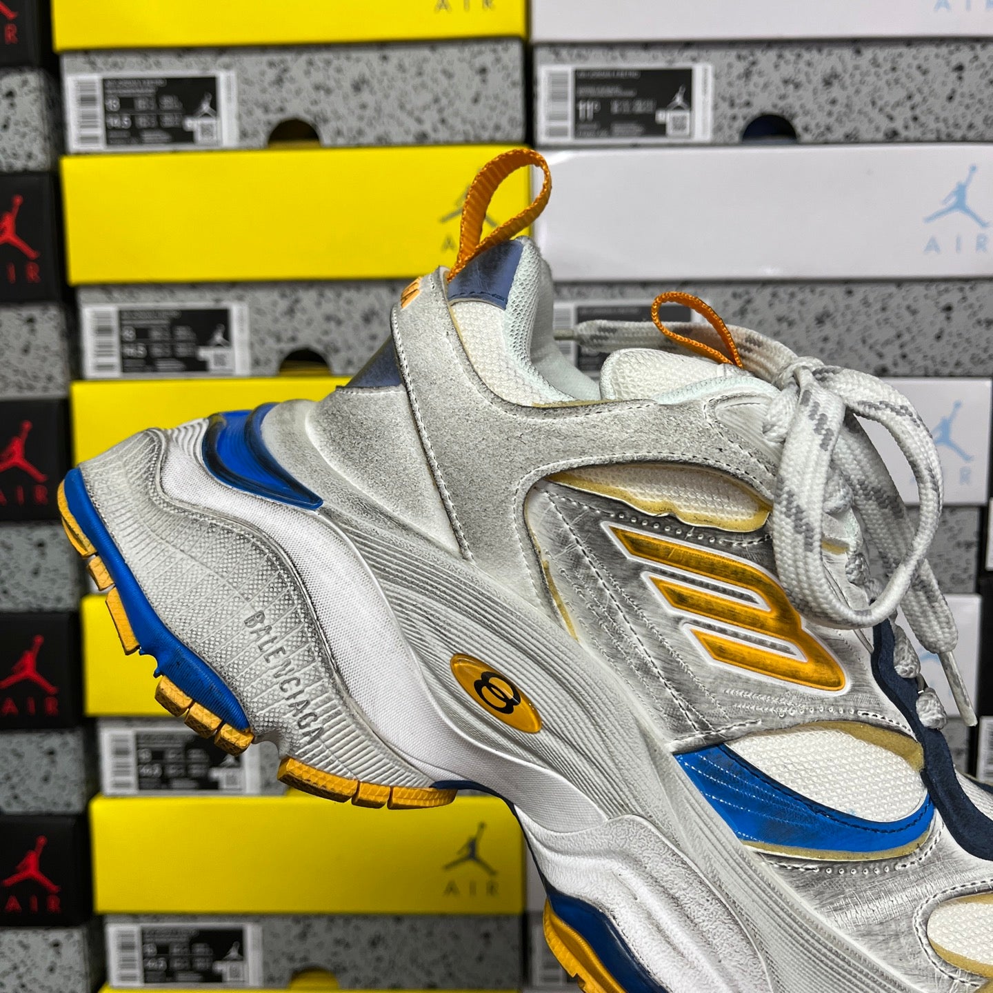 Balenciaga unisex sneaker front view with silver upper, blue panel, gold details