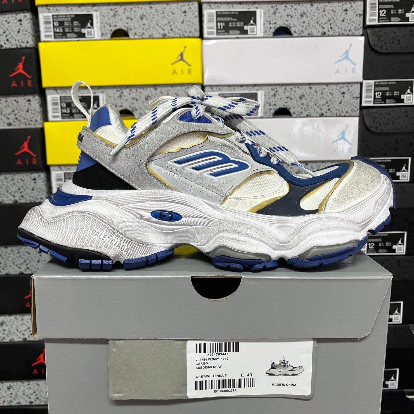 White and blue lace-up sneakers with gold accents and thick cushioned outsole