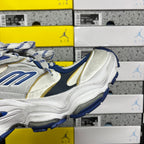 White and blue lace-up sneakers with gold accent panel and ridged sole