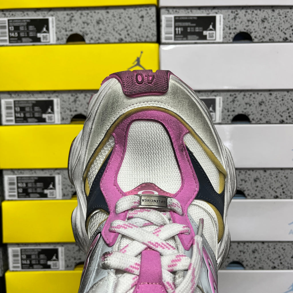 Toe view of silver and pink lace-up sneaker with textured upper