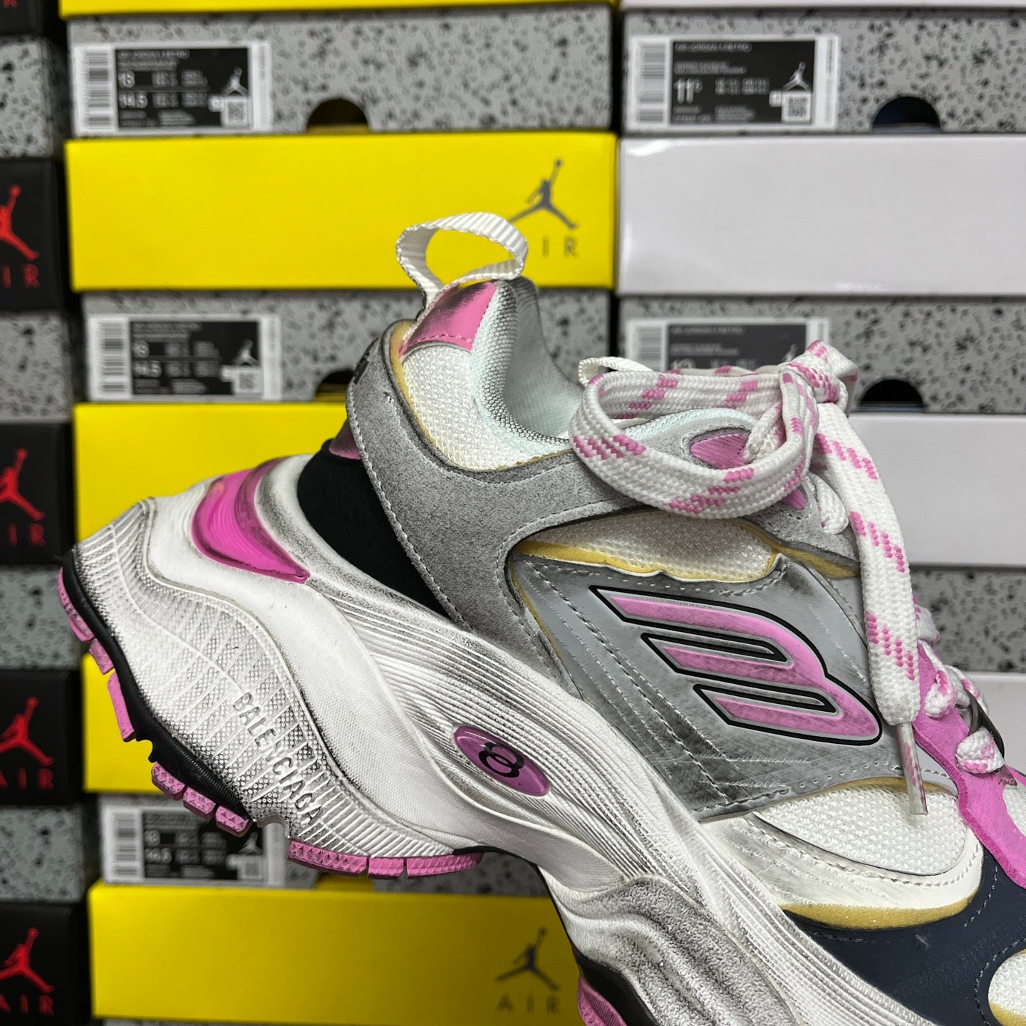 Lace-up sneaker in silver and pink with black overlay and pink trim