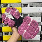Outsole view of pink and dark sneaker with textured tread pattern