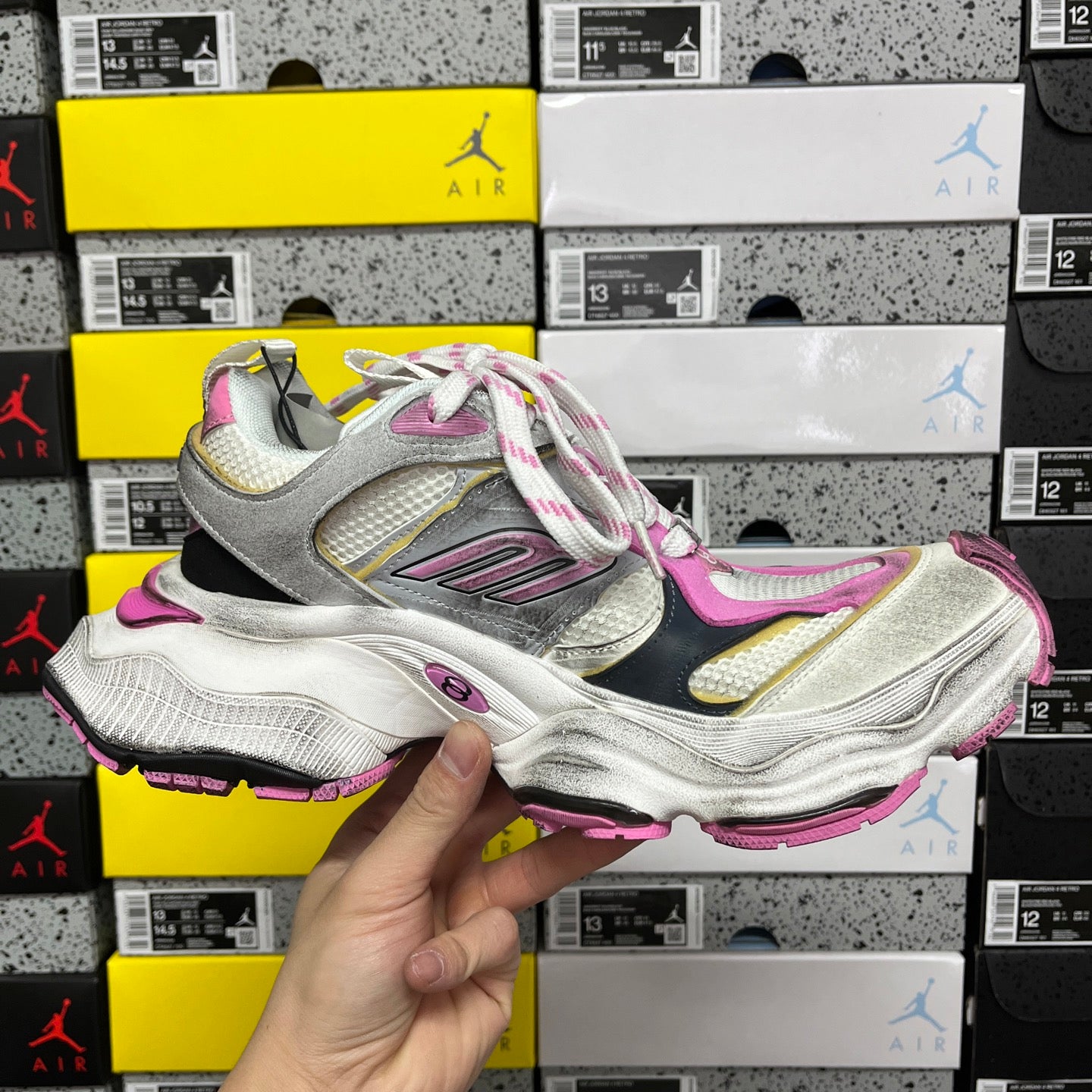 Top view of silver and pink lace-up sneaker with multicolor side accents
