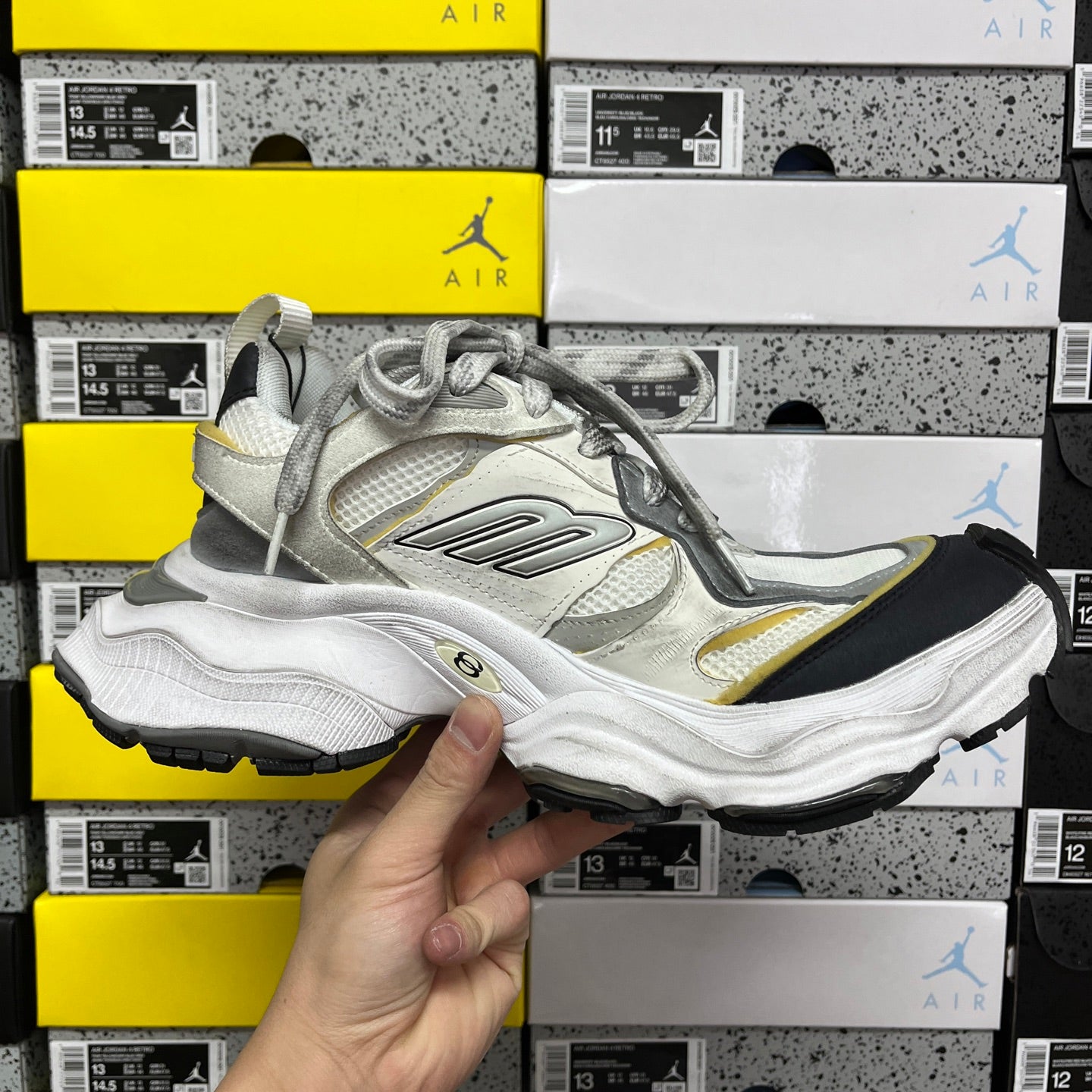 Balenciaga unisex sneakers, opposite side view in white and gray with yellow accent
