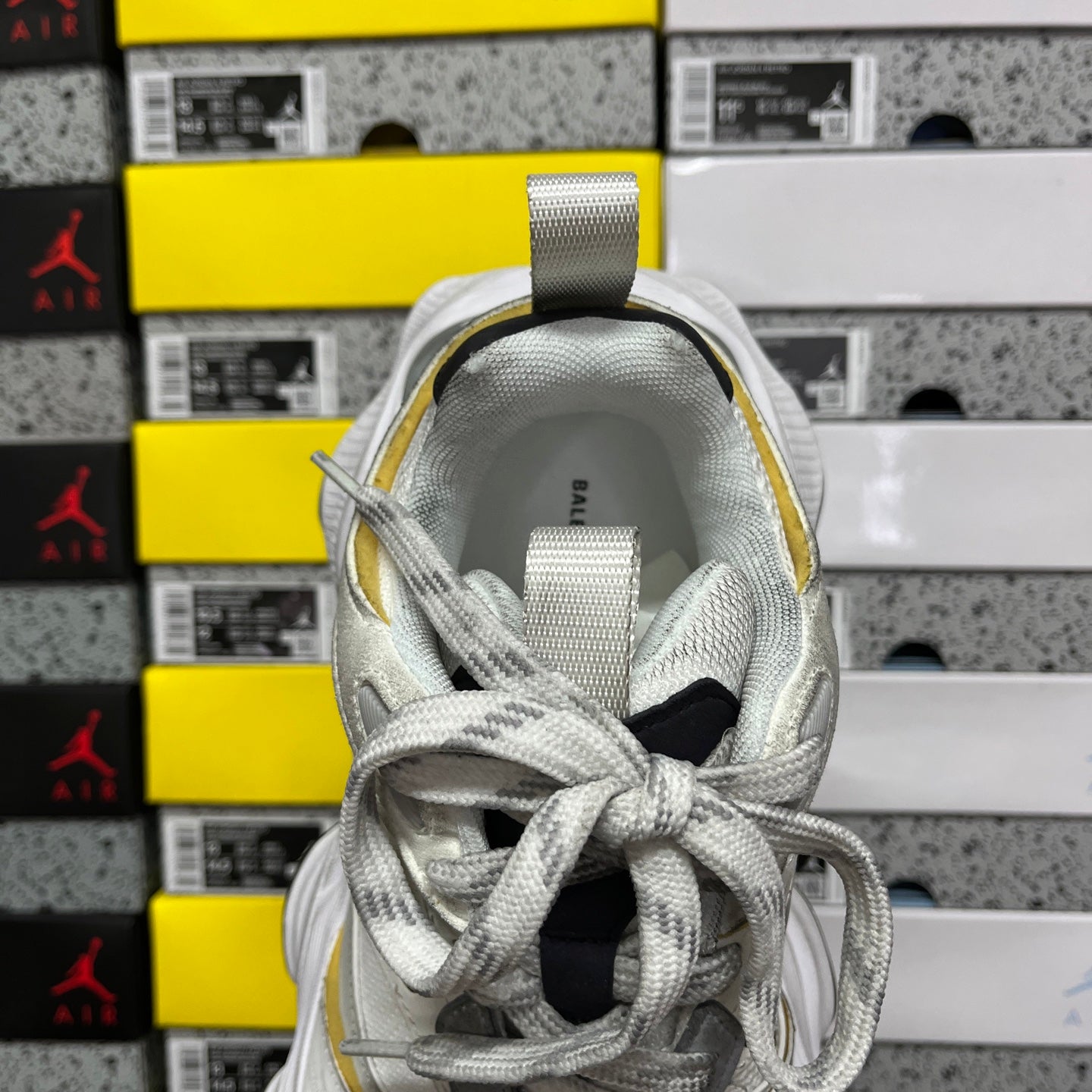 Balenciaga unisex sneakers, back view in white and gray with lace-up closure and yellow edge