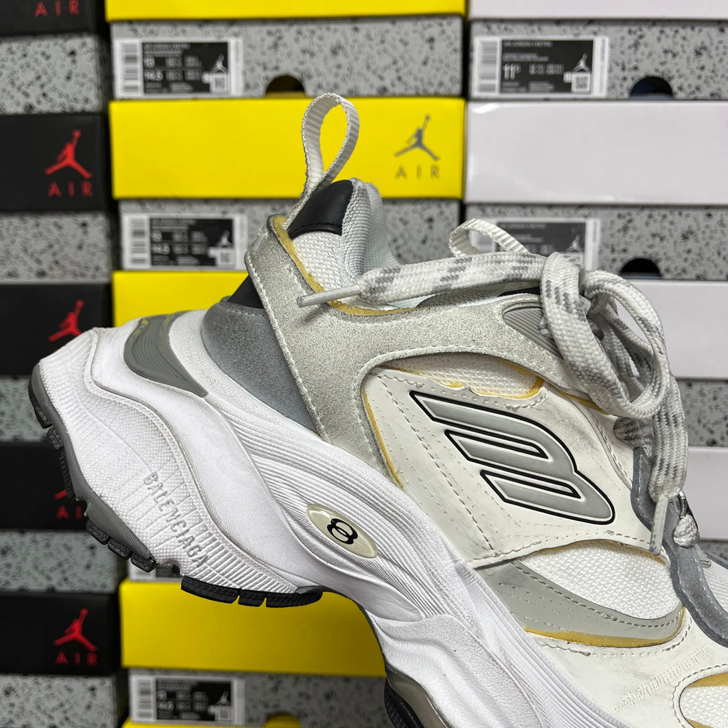 Balenciaga unisex sneakers, angled upper view in white and gray with yellow details