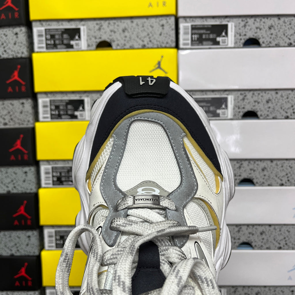 Balenciaga unisex sneakers, front view in white mesh with gray lining and yellow accent