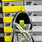 Back view of gray sneaker with neon yellow-green heel strap and lace-up closure