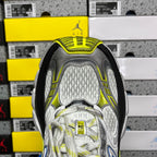Rear view of gray sneaker with neon yellow-green collar and textured mesh panels