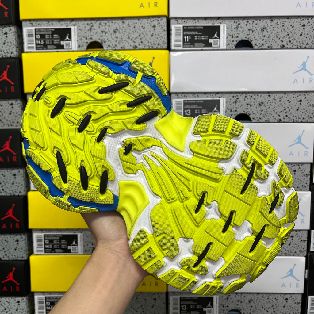 Top view of neon green and blue sneaker outsole tread with gray insets