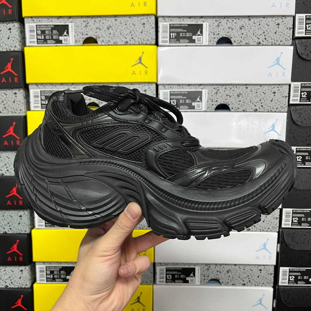 Black Balenciaga unisex sneaker, front-quarter view with lace-up mesh upper and cushioned sole