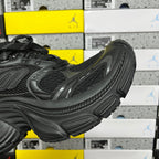 Black Balenciaga unisex sneaker, angled side view with sculpted upper panels and chunky sole