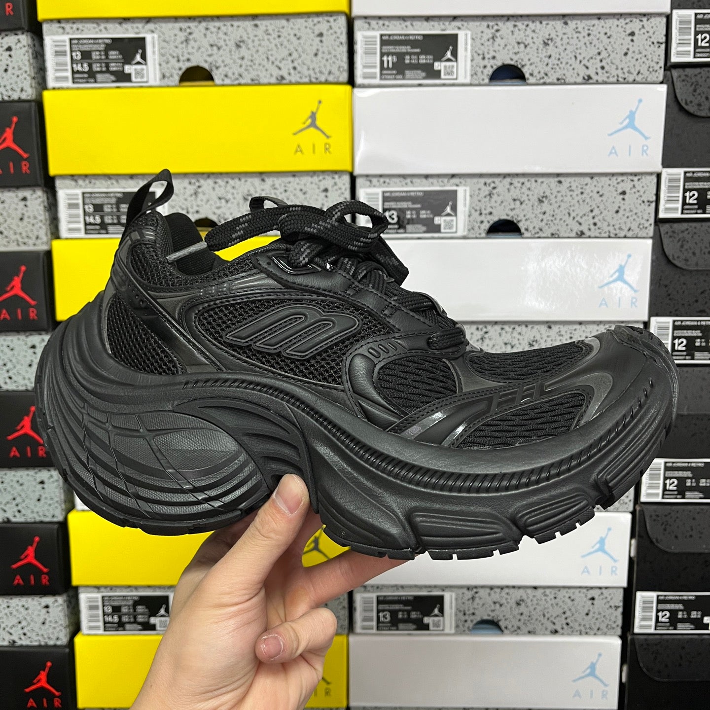 Black chunky Balenciaga unisex sneakers with mesh upper, lace-up front, and molded sole