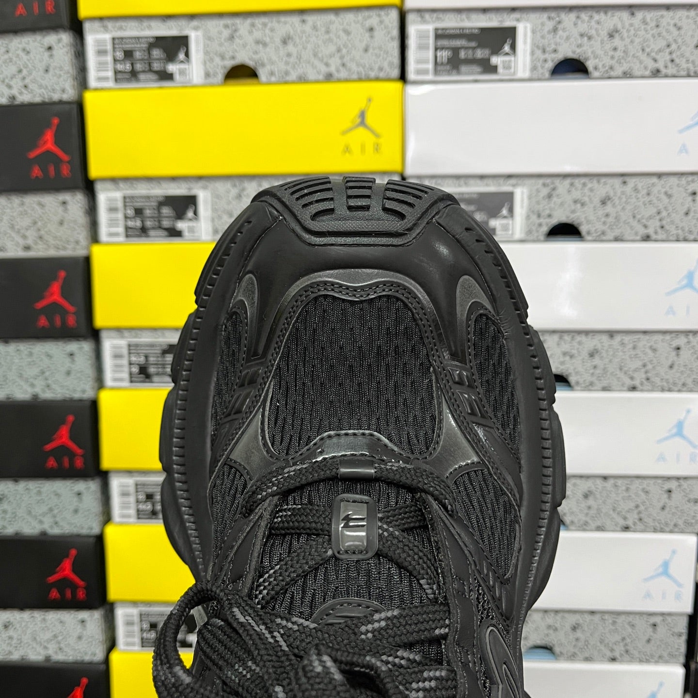Black Balenciaga unisex sneaker, top view with textured mesh tongue and lace-up closure